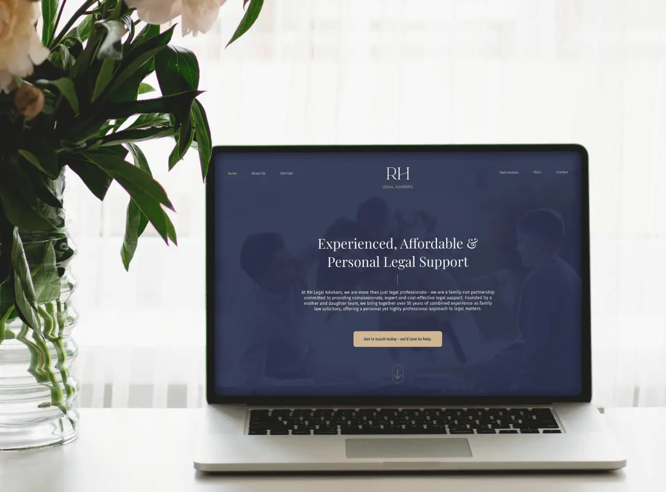Law firm website displayed on a laptop